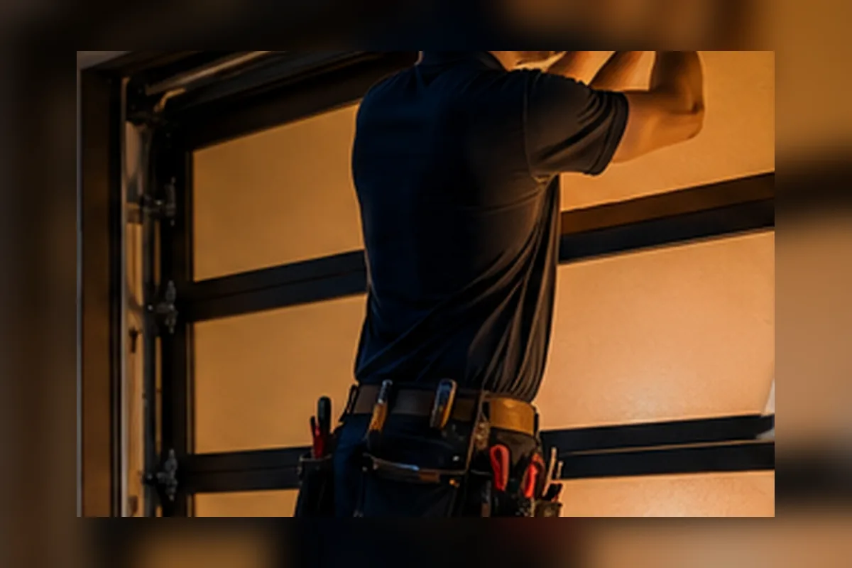 Garage door service technician working on a residential door